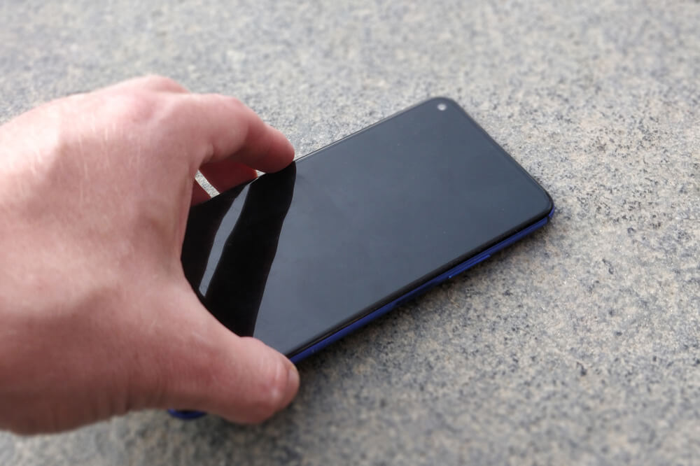 Picking a phone off the ground.